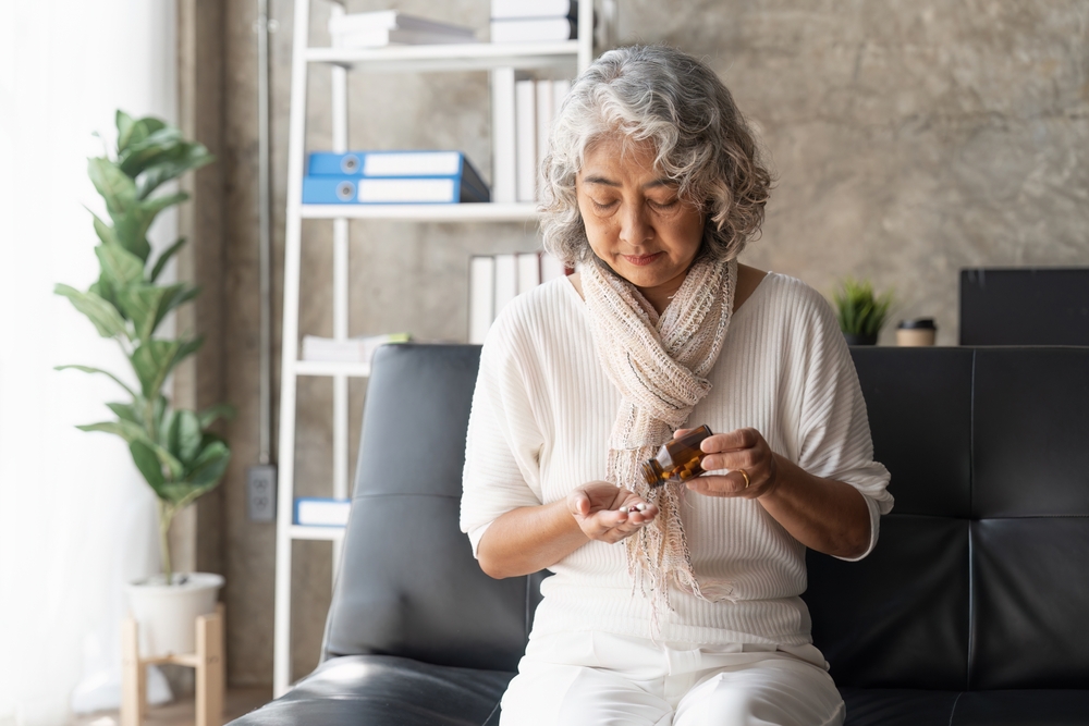 Lady taking medicine.