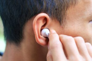 Person wearing earbuds.